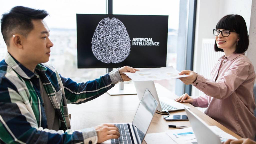 Professionals collaborating on an artificial intelligence project, representing the integration of AI tools in content marketing strategies.