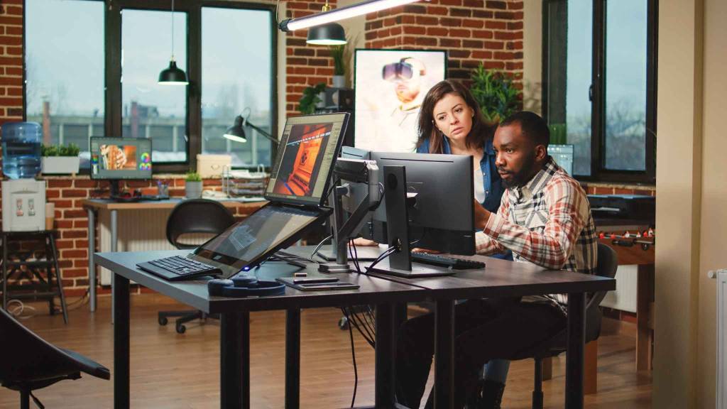 Designers collaborating with AI-enhanced software to optimize ad visuals and content for digital campaigns