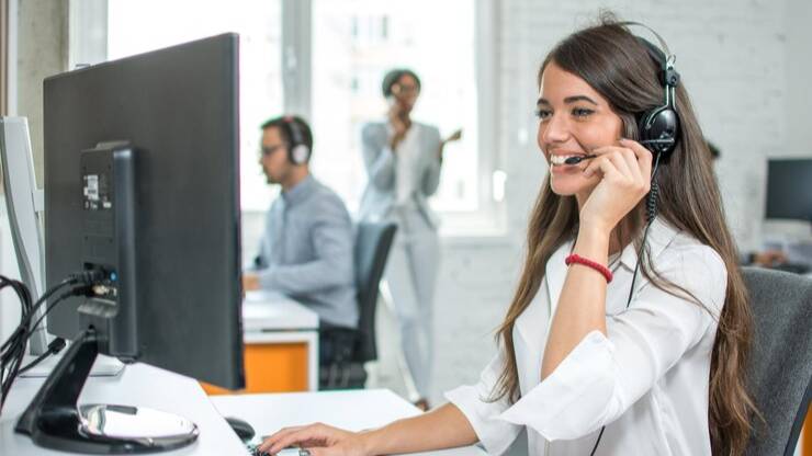contact center agent wearing a headset, enhancing customer service at a workstation