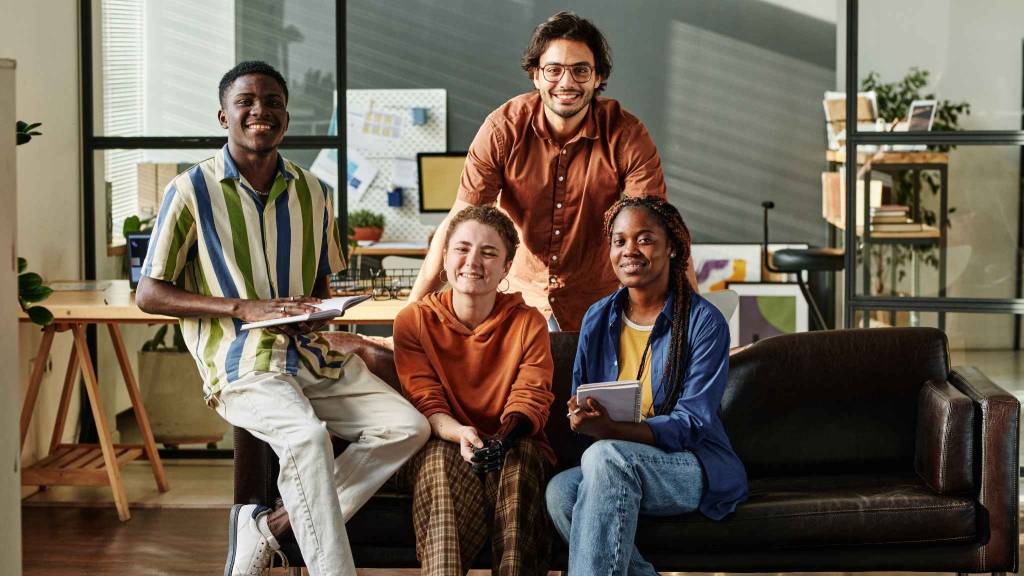 A diverse creative team in a modern agency environment, strategizing how to evolve with AI in advertising