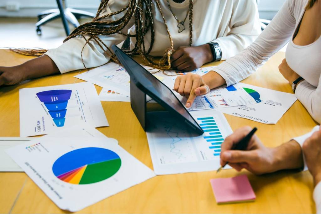 A marketing team analyzing data-driven marketing reports, discussing customer insights and predictive analytics for campaign optimization.