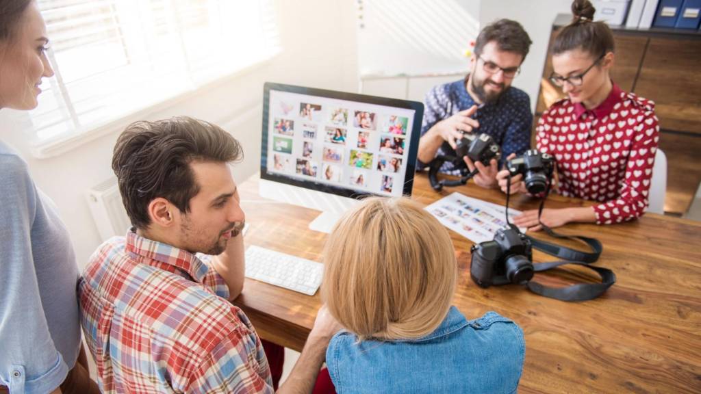 Team planning growth hacks for content marketing using digital visuals and strategy tools.