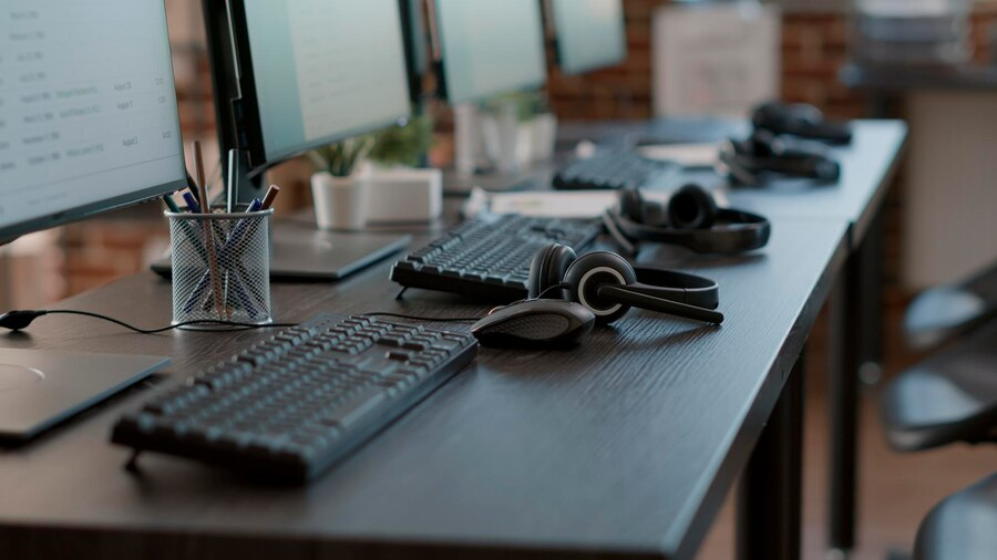 Contact center office with computers and headsets, enhancing customer experience and business success