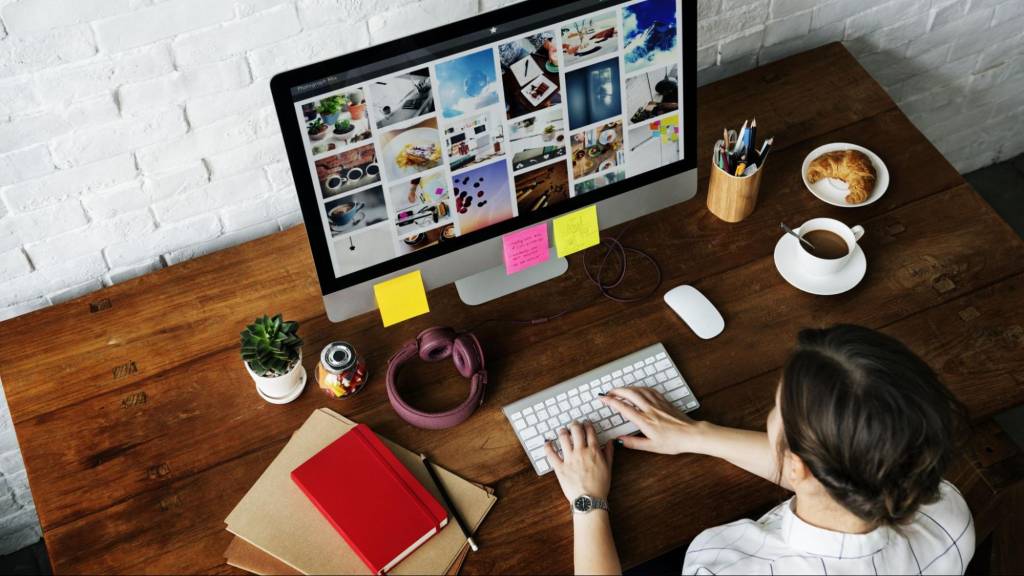 Creative professional designing visual content at a desktop computer—ideal setting for crafting SEO-optimized Instagram posts.