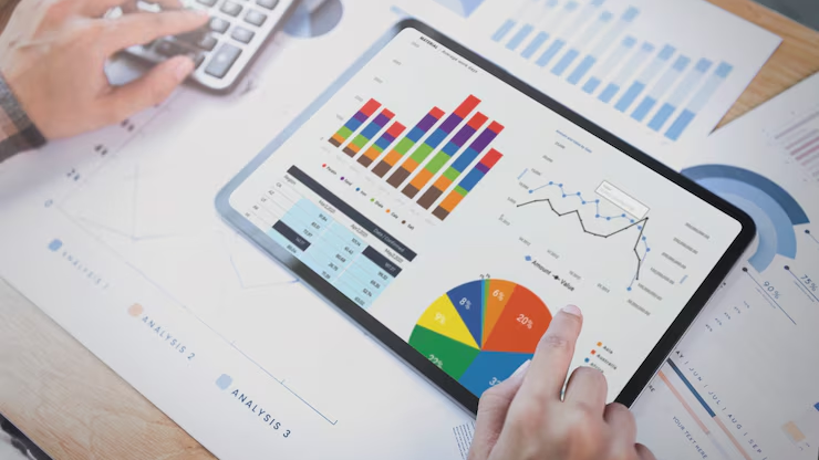 A person’s hand pointing to a tablet displays detailed information related to the results of a Quarterly Strategy for optimization.