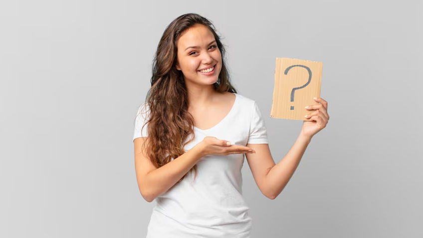 Woman holding a question mark sign, illustrating uncertainty and common pitfalls in poorly optimized PPC campaigns.