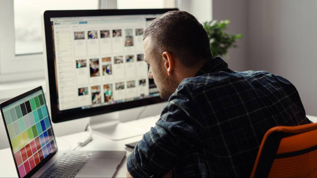 Social media manager reviewing Instagram content on a desktop for SEO optimization and search engine visibility.