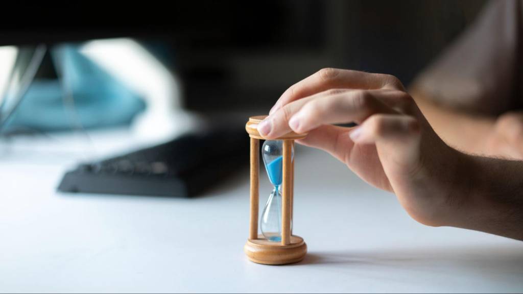 Hourglass symbolizing slow website loading speed affecting conversions on a silent sales killer website