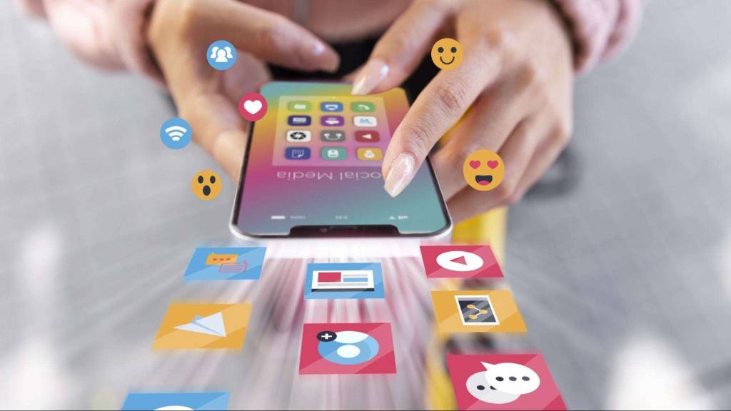 Close-up of a person using a smartphone with social media icons representing engagement, storytelling, and digital marketing strategy.