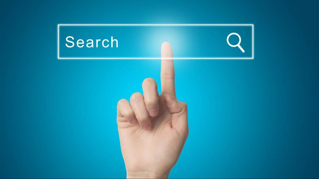 Finger tapping a digital search bar representing Google AI assistant and smarter search experiences for local business SEO visibility.