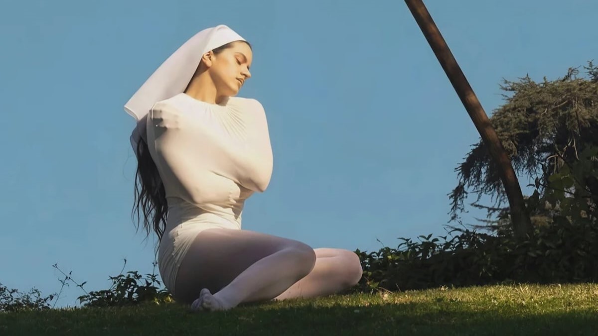 Rosalia posing in a white conceptual outfit from the Lux era, highlighting the artistic visuals used to support her experiential marketing campaign