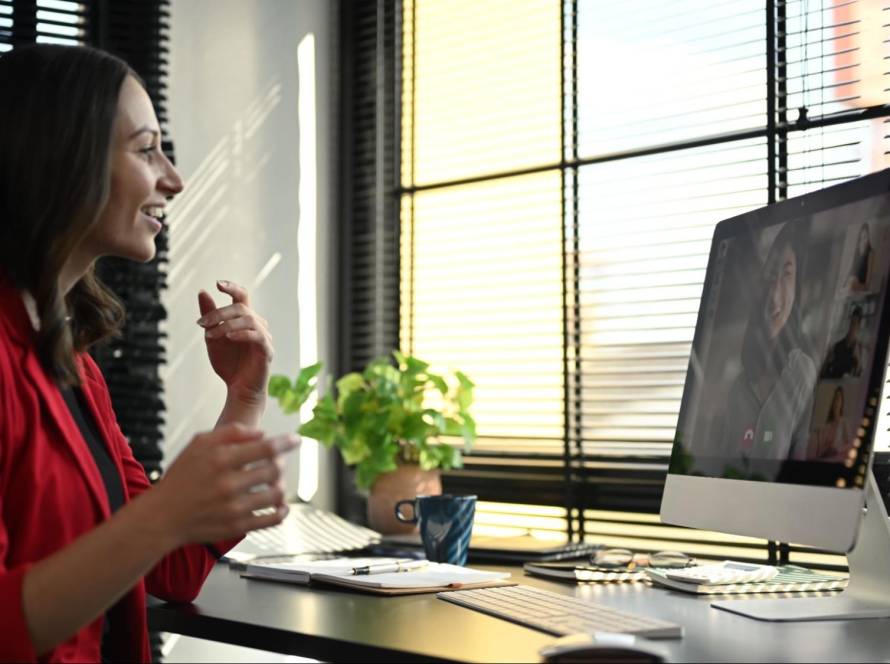 Business owner in Florida on a video call using a desktop computer for online marketing and SEO consultation.