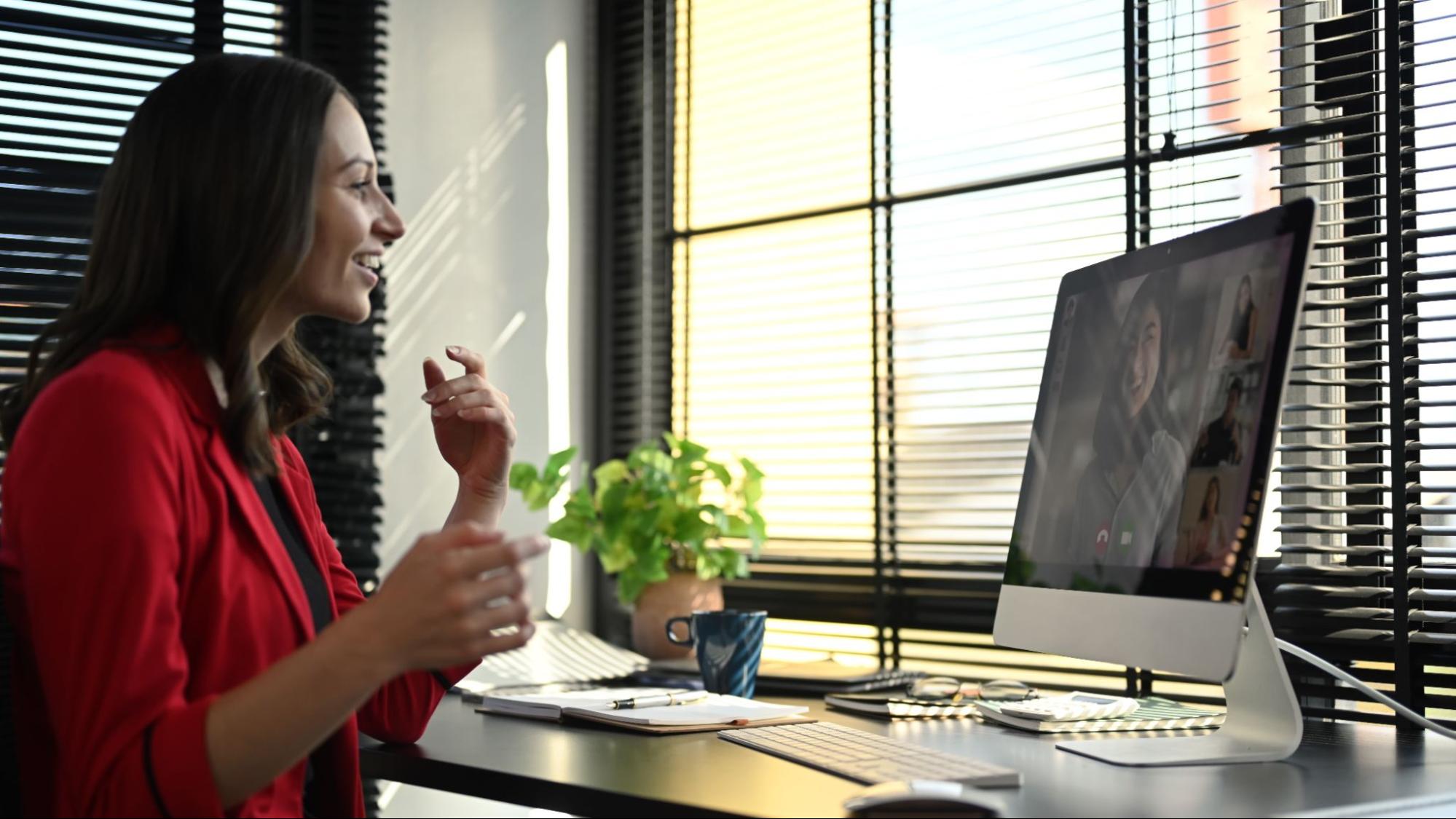 Business owner in Florida on a video call using a desktop computer for online marketing and SEO consultation.
