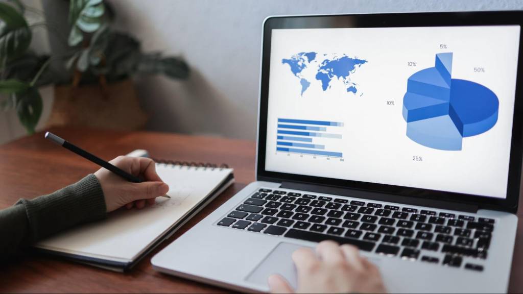 Small business owner reviewing SEO performance data and analytics as part of an SEO maintenance checklist in the AI era