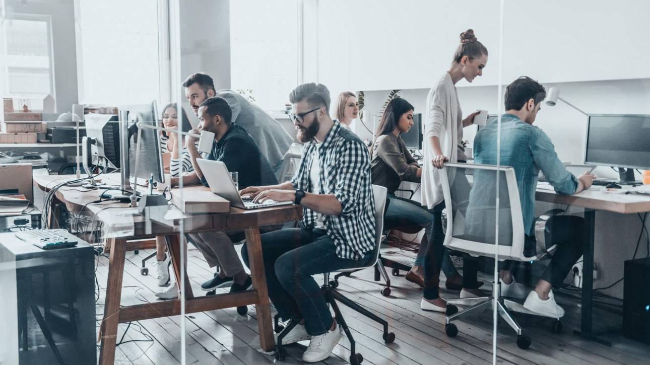 A team of digital marketing professionals working collaboratively in a modern office, illustrating the specialized SEO experts hired by tech giants and agencies.