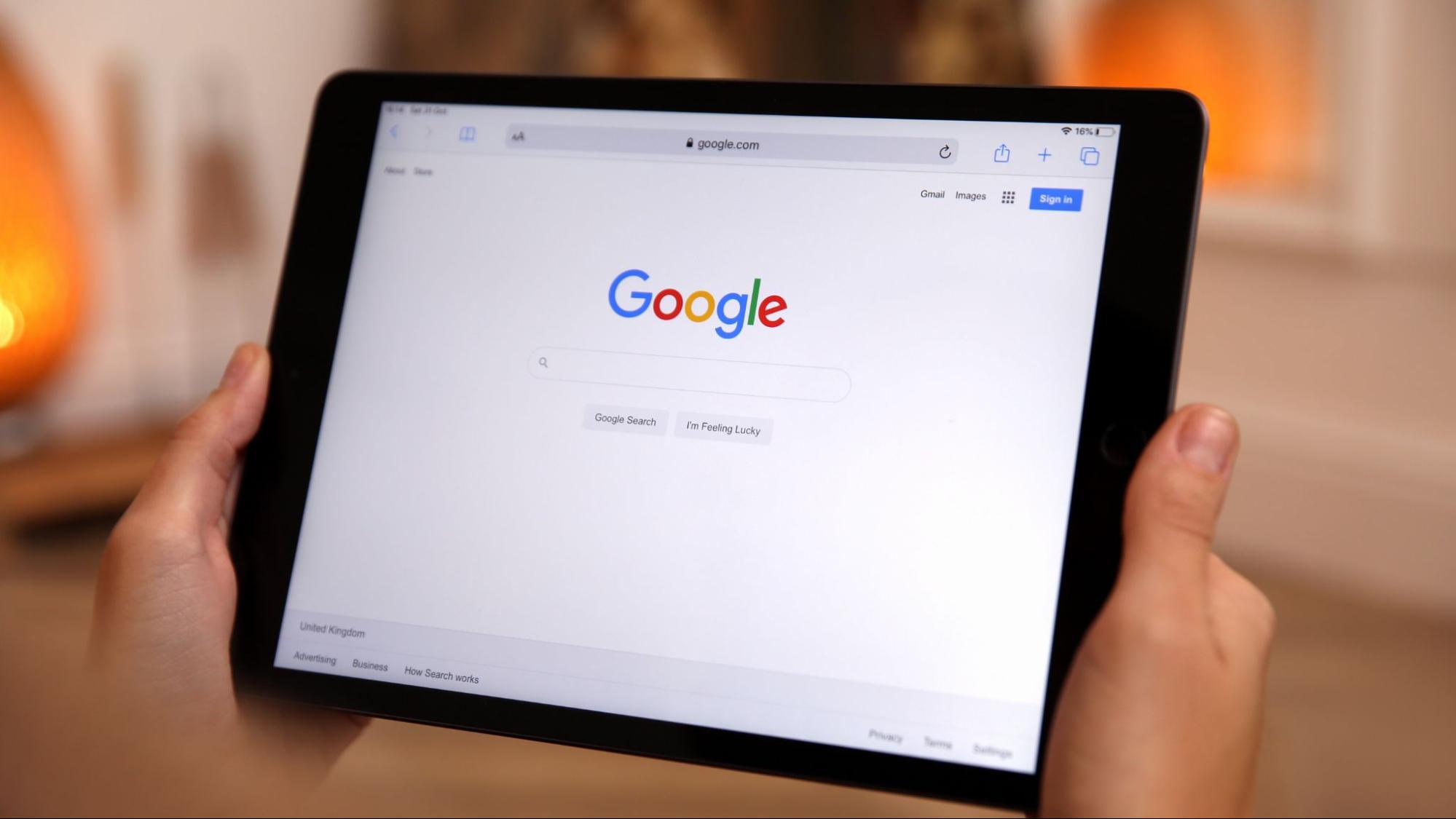 A person holding a tablet displaying the Google search homepage, highlighting Google’s New AI Strategy for Retailers and the shift to AI-first conversational search.