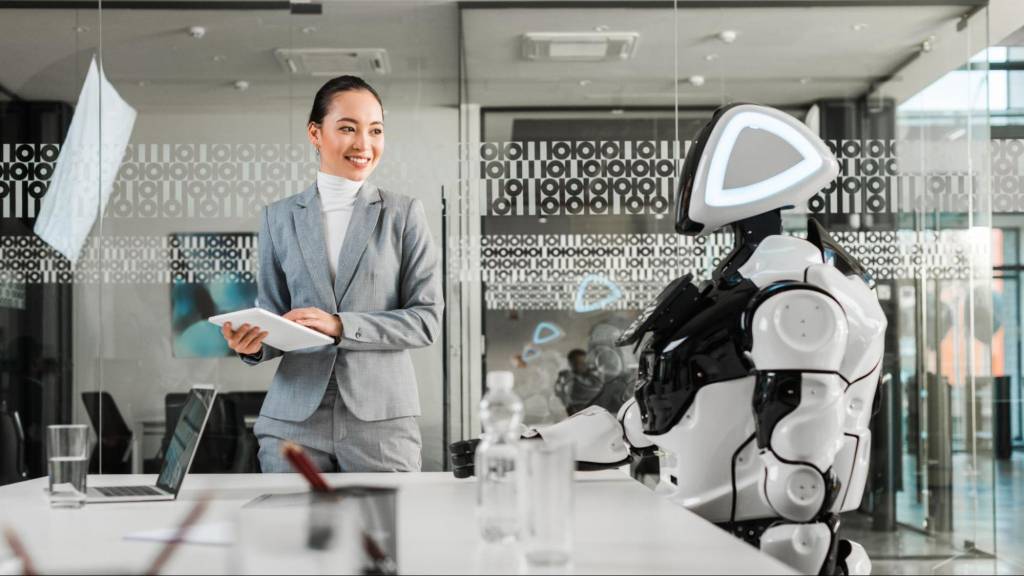 A professional businesswoman interacting with a futuristic robot in an office, representing Google’s New AI Strategy for Retailers and the rise of agentic shopping.