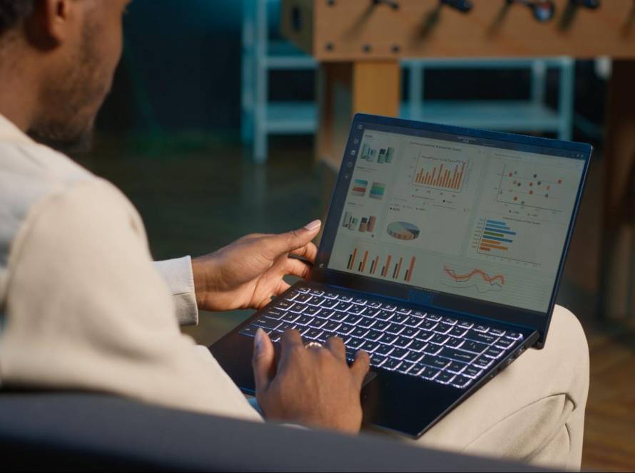 A digital marketing professional analyzing a complex data dashboard on a laptop, representing the process of ChatGPT traffic analysis and evaluating AI interaction metrics.